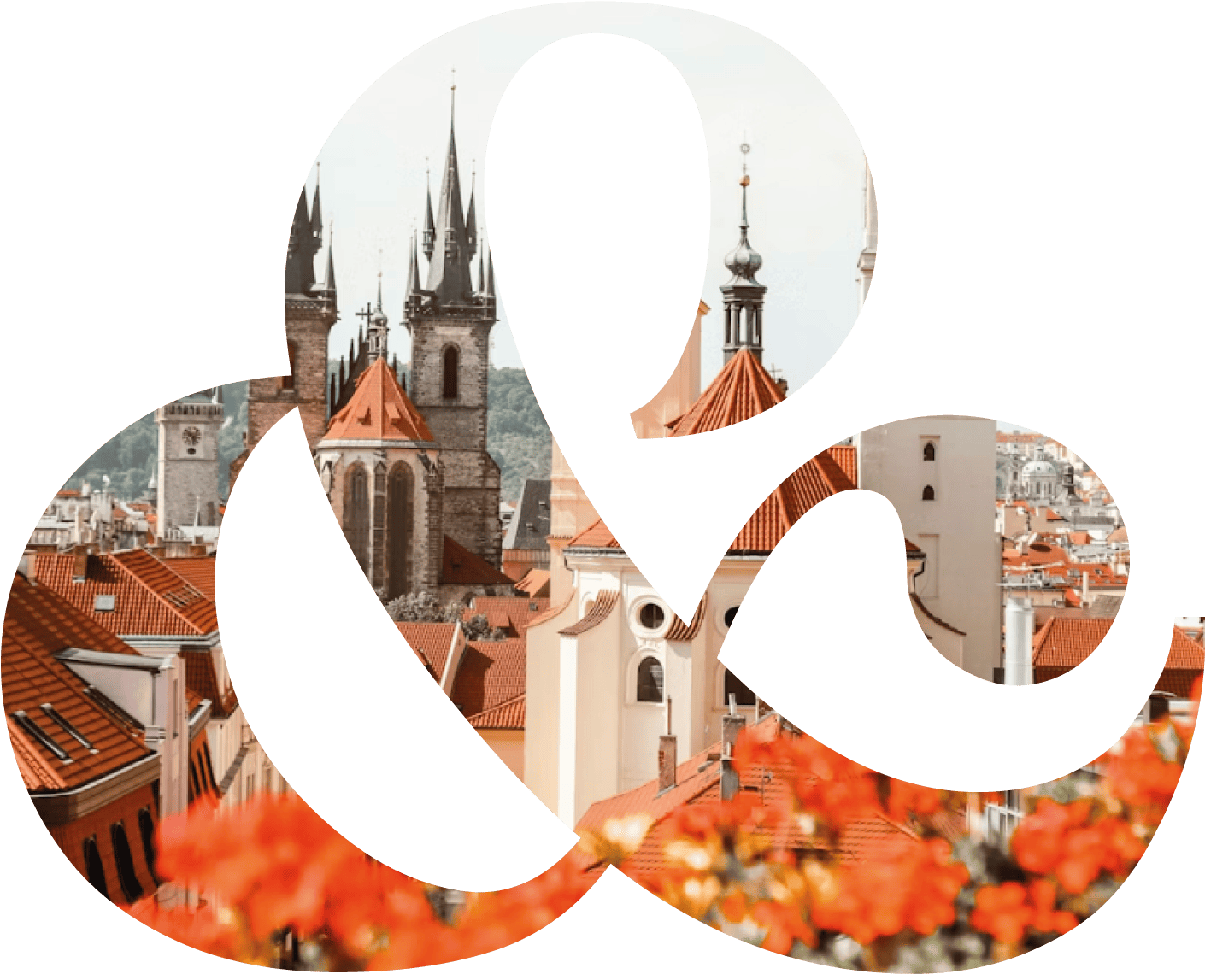 View of European city rooftops with red tiles and historic church towers, seen through an ampersand shape.